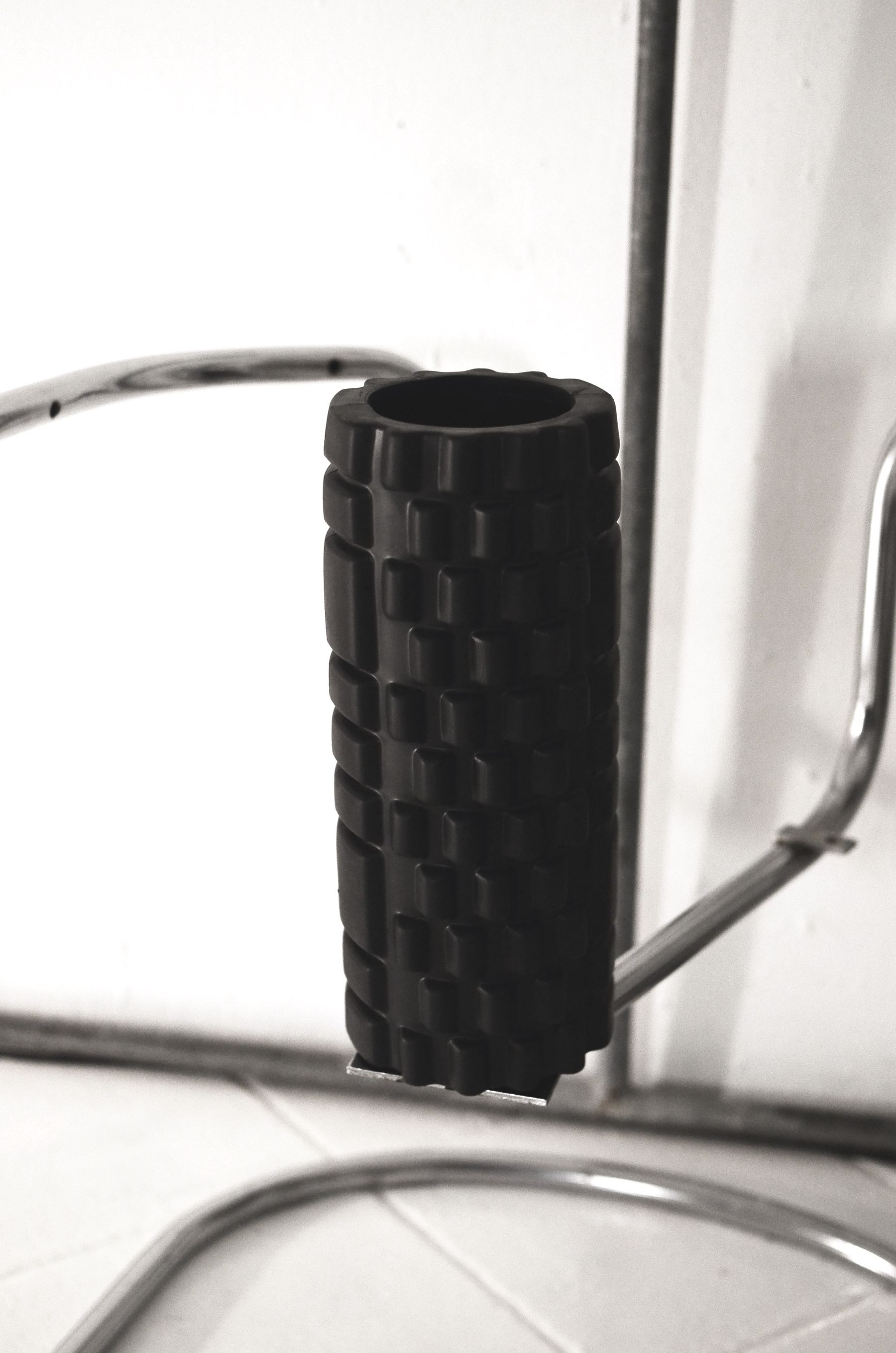 A textured foam roller used for muscle recovery