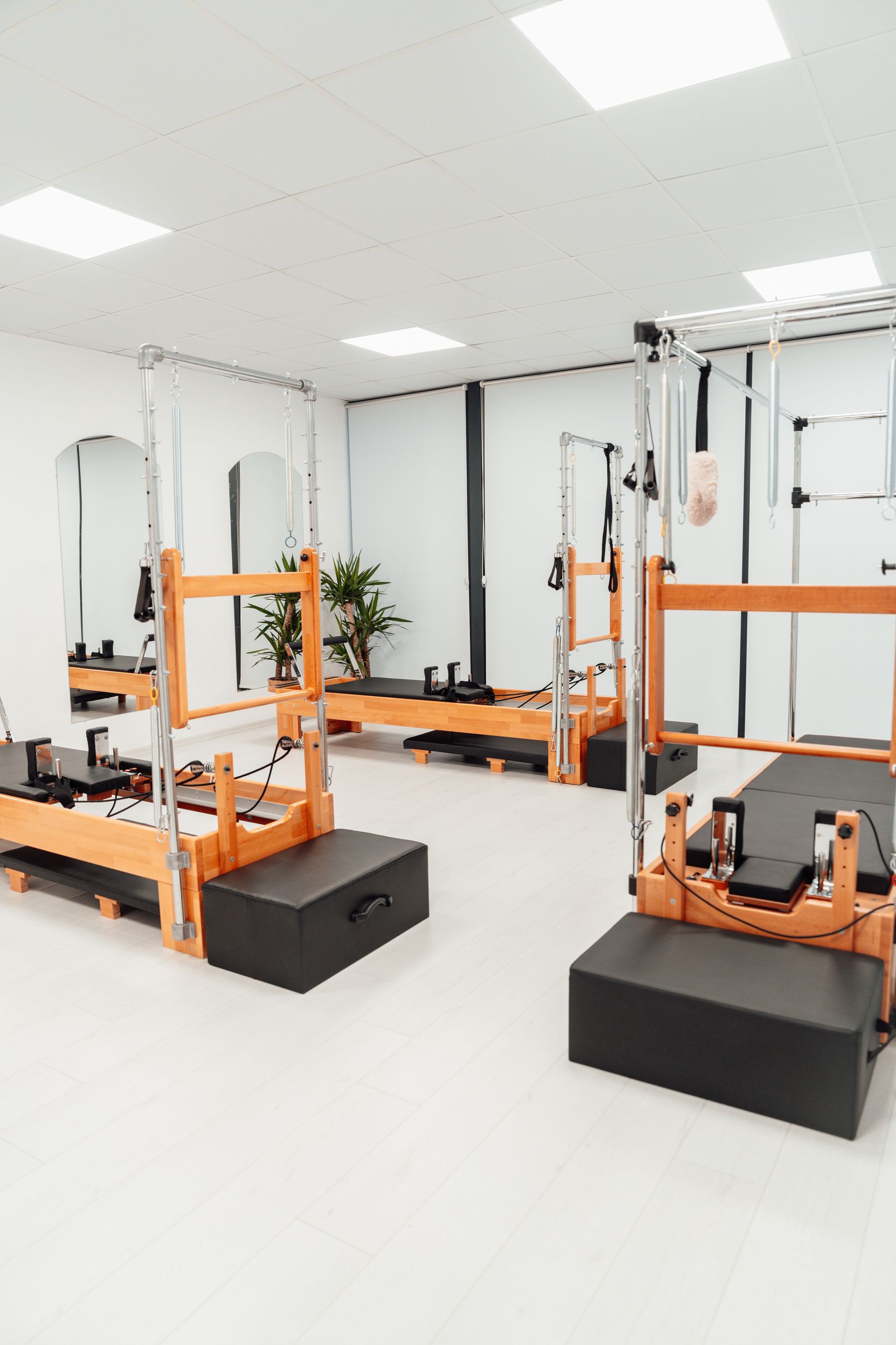 Pilates reformers and equipment in a light, airy studio